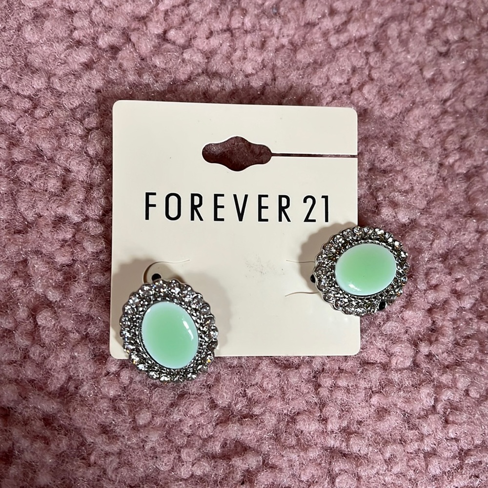 Silver and jade green stud earrings.